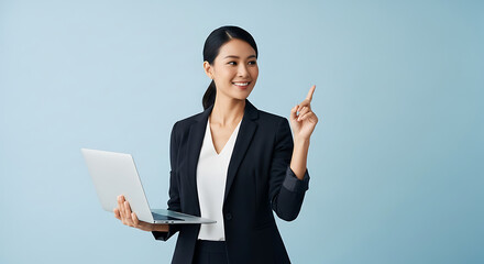 Confident Asian Businesswoman Pointing Up with Laptop