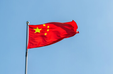 Chinese flag flying in the blue sky