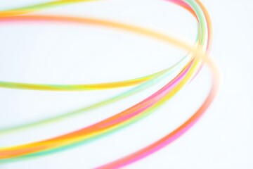 Colorful lines curve and flow dynamically across a white background creating an abstract and energetic design
