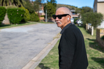 Senior man with pods and sunglasses