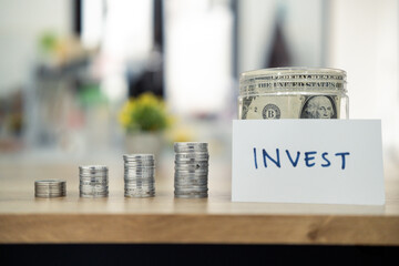 Coins grouped by size with a labeled jar displaying savings and investments, emphasizing growth and financial planning.