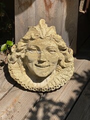 Antique Stone Face Sculpture in Afternoon Light

