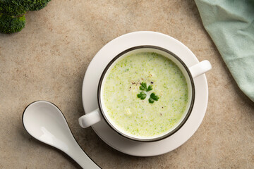 Cream of broccoli soup in white bowl.Healthy vegan dish.Top view.