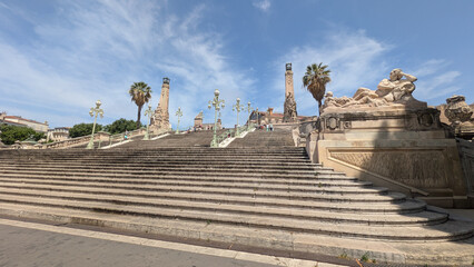 Marseille, France : Monumental staircase at Saint-Charles Station. Iconic landmark with sculptures, palm trees and historic architecture under a bright Mediterranean sky in summer.