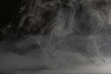 A dramatic shot of smoke or vapor, captured mid-air with an intense focus on droplet details, creating a sense of motion and energy Can represent power, release, transition, or transformation