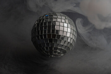 A shiny disco ball floats amidst smoke-like background, evoking a lively and nostalgic atmosphere...