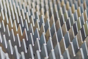 Fototapeta premium Close-up of stacked metal plates with ridged surfaces, resembling industrial machinery or heat exchange components Silver-gray to darker shades No branding Angled perspective, technical and utilit