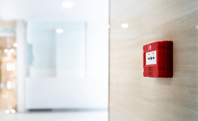 Red fire alarm button on the wall