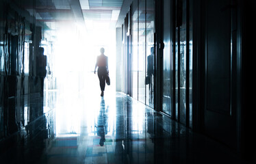 Woman walking on the dark corridor