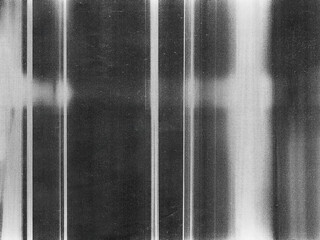 Old film texture with scratches, noise and glitch shapes. Realistic overlay film texture in black-white, dust and grain.
