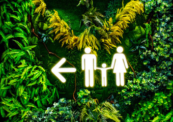 a family restroom sign illuminated in white, depicts a father, mother, and child, and a...