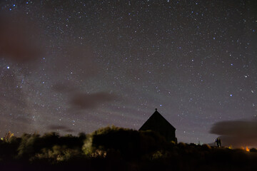 Starry Night Sky with Silhouette of Building