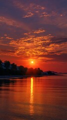 Vibrant Red And Orange Sunset Over Calm Ocean Water