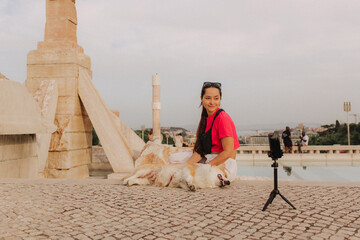 Young girl with Corgi recording video on phone share via app her travel vacation. Gen Z influencer...