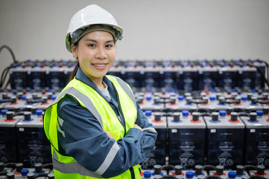 Technician inspects backup battery power system with confidence and safety gear in industrial setting ensuring reliable energy storage and efficient operation