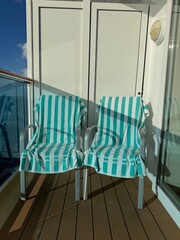 North Pacific Ocean, Alaska to Hawaii - Vacation Vibes: Sunlit balcony at sea with striped towels...