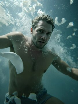 Man, intense, underwater, surrounded by petals, dramatic scene
