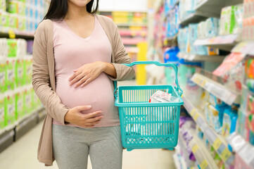 Pregnant woman shopping newborn products in the mall