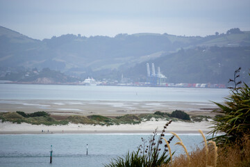 Tranquil Coastal Landscape with Port and Distant Hills