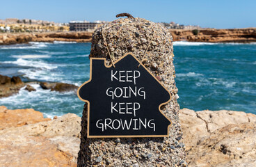 Keep going and growing symbol. Concept words phrase Keep going keep growing on beautiful black...