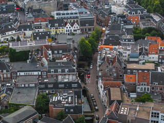 Aerial image of Utrecht, Netherlands, featuring gabled roofs, brick facades, narrow streets, trees,...