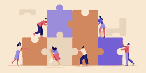 Diverse team of people working together to assemble a large jigsaw puzzle