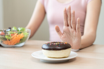 Women avoid to eat dessert while controlling their diet session.