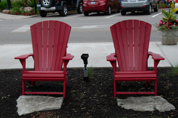 Two red chairs in a car park