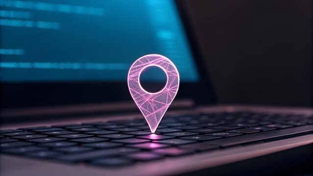 Glowing pink digital location pin hovering over a laptop keyboard with code on screen - Powered by Adobe