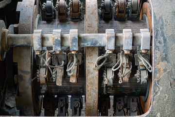 interior of an old, dusty electrical device with visible coils, terminals, and wires. Components...