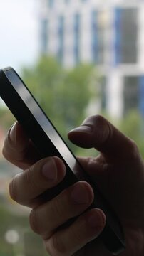 A man uses a mobile phone to read news or an e-book.
Business guy writes a message on the phone, reads the news and chats.
Work correspondence online