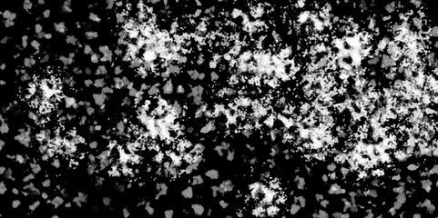 White snowflakes on a black background surface. Macro nature pattern backdrop. Snow overlay background isolated on black. Winter concept. scratches and cracks which can be used as a background.