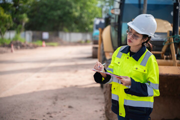 Civil Engineers, Managers, and Site Supervisors Collaborating on a Construction Site to Ensure...