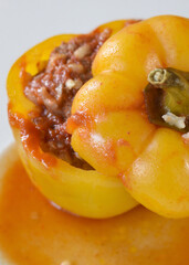 Cooked yellow bell pepper stuffed with ground meat and rice

