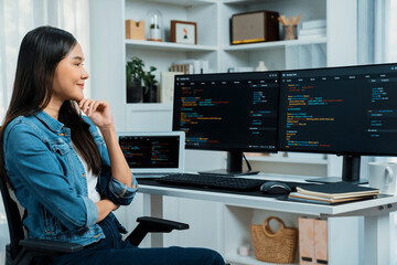 Young Asian IT developer looking online information on pc for beautiful pose with coding program...