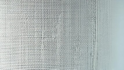  White machine-woven fabric with consistent textures and patterns, highlighting its efficiency and uniformity