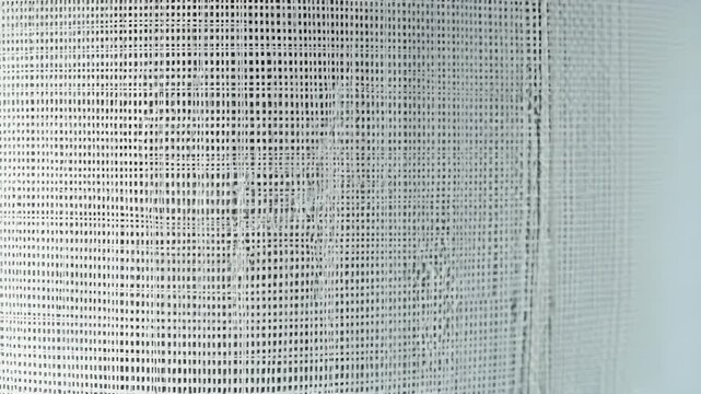  White machine-woven fabric with consistent textures and patterns, highlighting its efficiency and uniformity