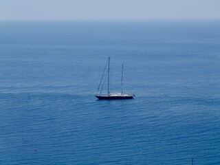 The yacht is in the Mediterranean Sea, close to the town of Taormina on the east coast of Sicily....