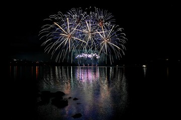 Beautiful colorful fireworks with reflections in water. Brno dam, the city of Brno-Europe. International Fireworks Competition.