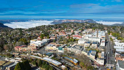 Drone aerial photograph of the picturesque and tourism town of Katoomba and the Jamison Valley full of low level clouds in the Blue Mountains, NSW, Australia.