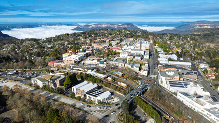 Drone aerial photograph of the picturesque and tourism town of Katoomba and the Jamison Valley full of low level clouds in the Blue Mountains, NSW, Australia.