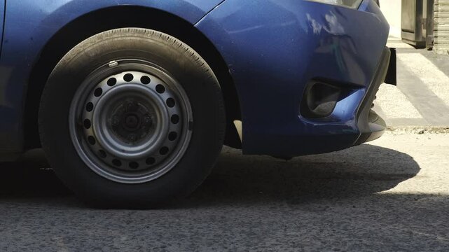 Close-Up of a Blue Car Tire Suddenly Braking and Coming to a Halt – Emergency Stop