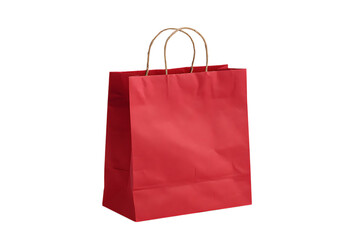 Red paper shopping bag with gold handles, isolated on black background.