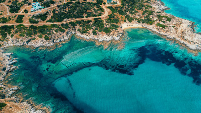 Aerial Drone View of Tigania Beach, Sithonia, Halkidiki, Greece - Crystal Clear Turquoise Waters and Rocky Coastline