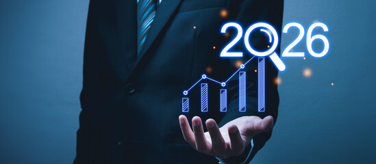 Business Growth Strategy. business man in suit with graph chart diagram on year 2026, investment, business planning, change from 2025 to 2026, goal target, growth and development company concept