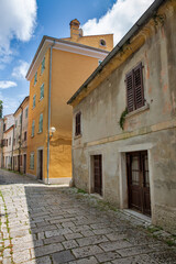 Historic cobblestone street in mediterranean old town Porec, Croatia.