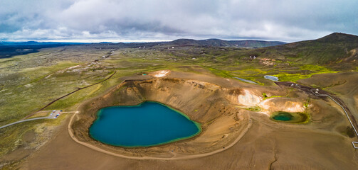 Aerial drone view of small volcanic Krafla lake with azure water, Iceland