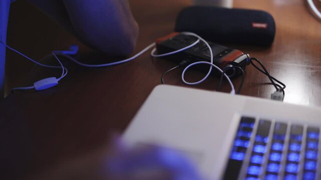 Rack Focus from Composer&rsquo;s Hands Scoring Music on Laptop to Audio Recorder on Desk &ndash; Creative Studio Environment