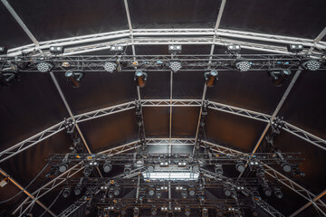 Detailed view of professional concert lighting setup with multiple suspended LED spotlights and...