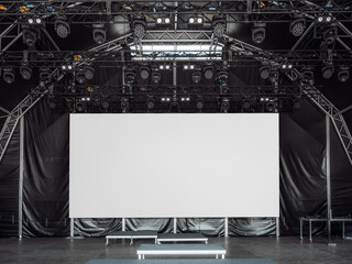 Large white LED screen or digital billboard mockup on a professional stage with lighting rigs and...